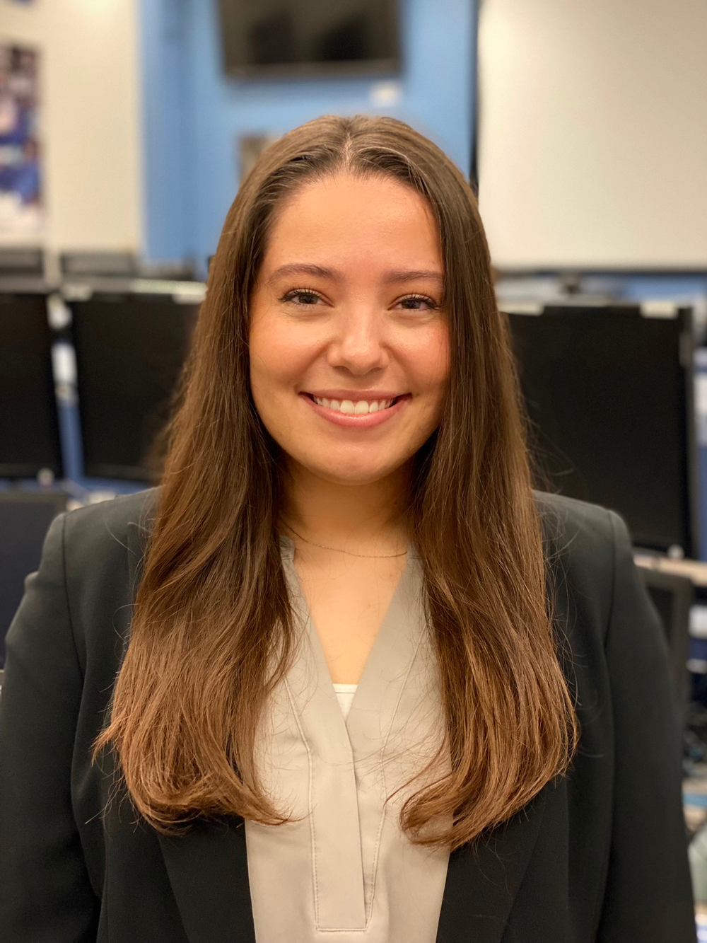 Professional portrait of a young woman with long brown hair.